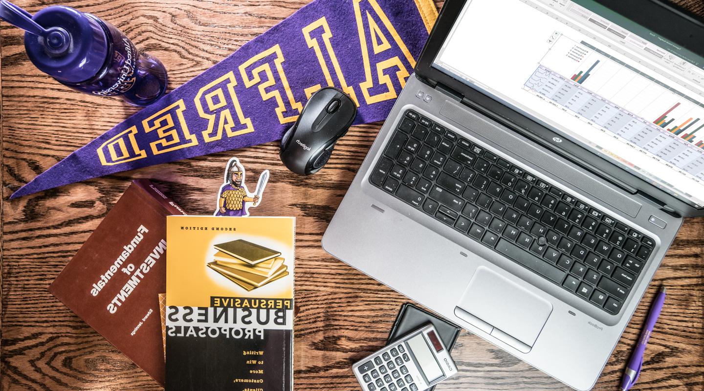 laptop and business books on a desk